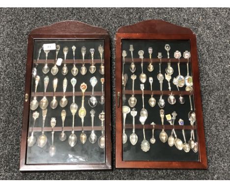 Two spoon display cases containing a quantity of continental silver and plated teaspoons. 