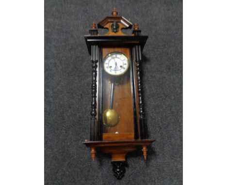 A 20th century mahogany Vienna wall clock with brass and enamel dial. 