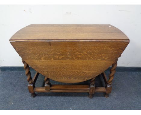 An Edwardian oak barley twist gate leg table.  