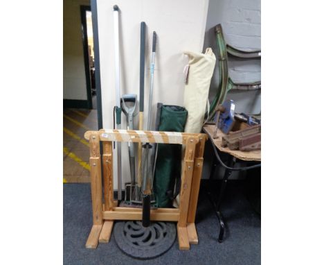 A pair of pine trestle stands together with a garden parasol with stand, folding chair in bag and small quantity of garden to