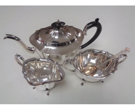 A three piece silver plated tea service together with a plated spoon
