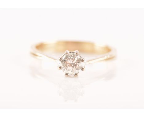 A 14 carat gold solitaire ring, featuring a round brilliant cut diamond with an approximate weight of 0.40 carats set in a wh