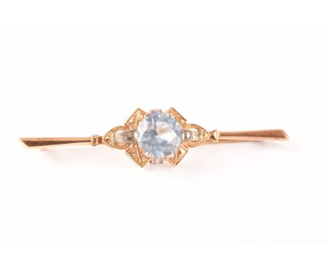 An 18ct yellow gold and platinum bar brooch, set with a round cut aquamarine with an approximate weight of 3.30 carats, 6.5cm