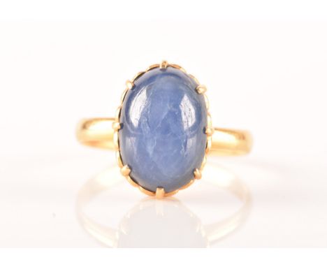 A yellow gold and cabochon sapphire ring, set with an oval cabochon sapphire (showing mild asterism), eight claw set, shank u