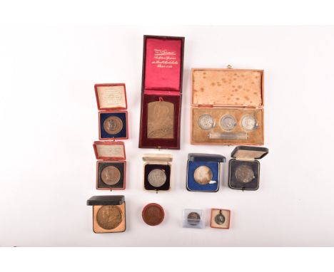 A collection of Commemorative Coronation silver, silvered and bronze medals, a cased triple medal set of the Three British Ki