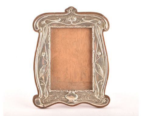 An Art Nouveau silver and wood photo frame, hallmarked for Chester 1905 by William Neale, with impressed birds and floral dec