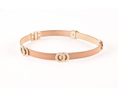 Bulgari. A tan leather double coiled wrap bracelet with gold tone hardware, the interlocking rings featuring signature engrav