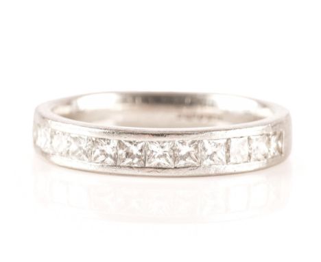 A platinum half eternity ring, set with twelve square princess cut diamonds with a combined approximate weight of 0.60 carats