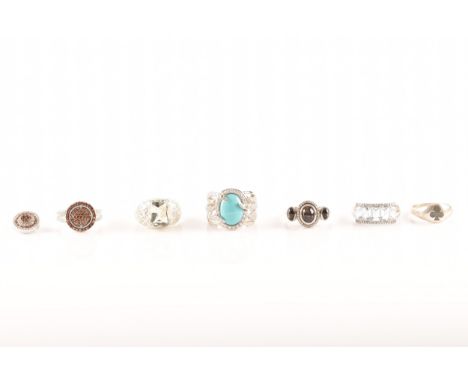 A group of assorted rings, including five silver rings set with various gemstones, two of which are set with diamond accents,