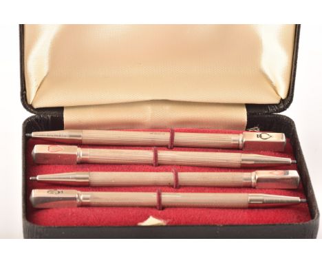 A boxed set of four silver bridge pen markers, hallmarked for Birmingham 1995 by&nbsp;William Manton, with stamped playing ca