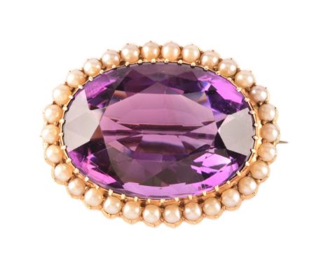 A 10ct yellow gold amethyst and pearl brooch, set to centre with a oval cut amethyst measuring approximately 25 x 17 x 12mm, 