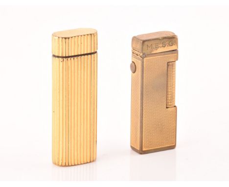 A Cartier gold plated ribbed cigarette lighter, signed Cartier and numbered&nbsp;A44844 to the base, together with a Dunhill 