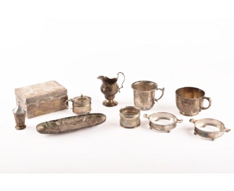 A group of assorted silver items, including a silver cigarette box, two silver mugs, a silver cream jug, a silver napkin ring