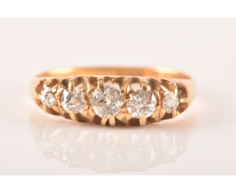 A late 19th / early 20th century 18ct yellow gold and diamond ring, set with five graduated old-cut diamonds, the central sto