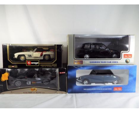 Sun Star, Burago and Maisto - four boxed diecast vehicles 1:18 scale comprising a Citroen DS 19, a London taxi TX1, an Audi R