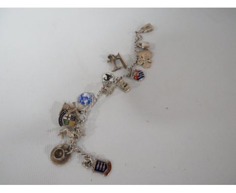 A VINTAGE SILVER CHARM BRACELET