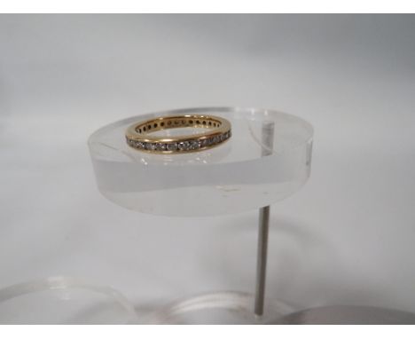 AN 18K CHANNEL SET  DIAMOND FULL ETERNITY RING ring size n 1/2 approx weight 3.9g 