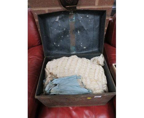A TIN TRUNK CONTAINING A VINTAGE WEDDING DRESS TOGETHER WITH OTHER VINTAGE CLOTHING  