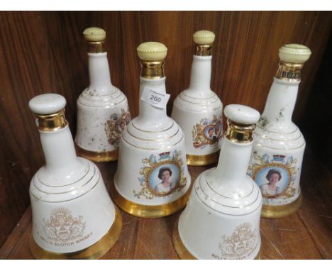 A SET OF SIX BELLS SCOTCH WHISKY DECANTERS 