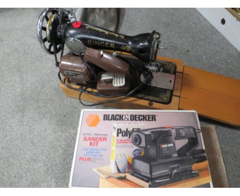 A SINGER SEWING MACHINE WITH A DOUBLE DECKER SANDER 
