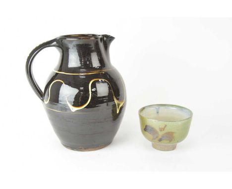 ARR Ray Finch (1914-2012) Winchcombe Pottery - A slipware jug with cream trails, 24cm high; and a small bowl, green glaze to 