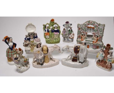 A collection of Staffordshire portrait figures, mid-19th century, comprising a flatback Wedding Couple arbour group, 35cm hig