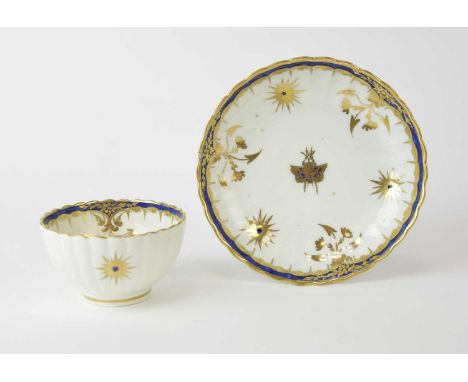 An uncommon Caughley 'Blue and Gold Star and Fly' tea bowl and saucer, circa 1790, or reeded form, decorated in underglaze bl