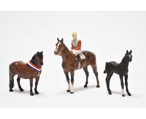 A group comprising a Beswick jockey on horse with no. 12 colours, model 1862, a Beswick 'Another Bunch' Dartmoor pony and one