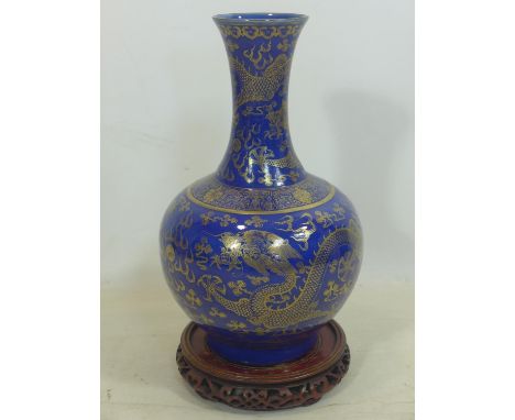 A late 19th / early 20th century Chinese powder blue and gilt vase, decorated with dragons chasing the flaming pearl, H.40cm,