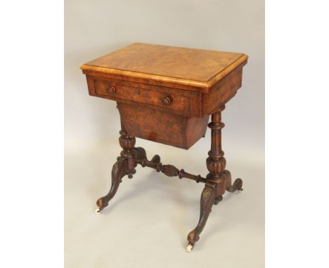 A Victorian burr walnut games/work table, the rectangular quarter veneered top hinged to reveal backgammon board, cribbage bo