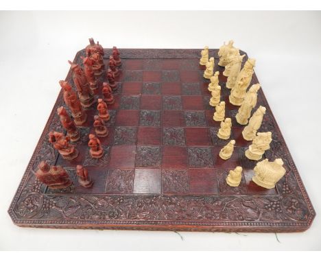 An oriental style resin chess set, and a chess board. 