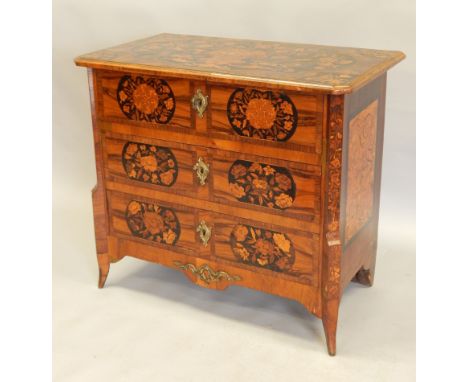 A late 18th/early 19thC Dutch walnut and floral marquetry commode, the rectangular top with canted corners above three drawer