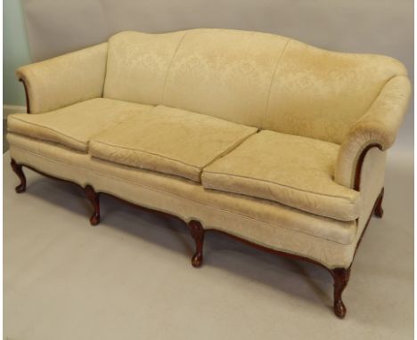 A mid 20thC mahogany three seat sofa, upholstered in damask type fabric, on four carved cabriole legs, 181cm wide.