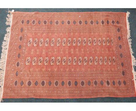 A modern Afghan type carpet, with a design of medallions on a brown ground with multiple borders, 186cm x 133cm.