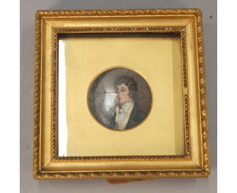 An early 19thC porcelain plaque, painted with a portrait of a gentleman wearing a green coat, unsigned, (AF), 9cm diameter. 
