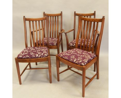 A set of four Ercol elm slat back dining chairs, each with a loose cushion on turned legs, two with arms.  The upholstery in 