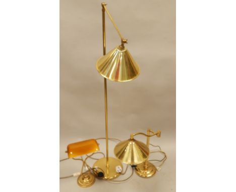 Three modern brass light fittings, an adjustable standard lamp, a desk lamp with amber coloured shade, etc. 