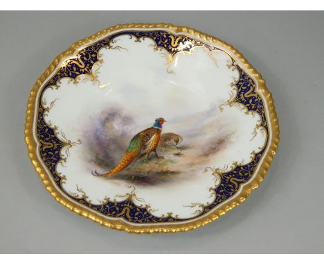 A Royal Worcester cabinet plate, painted centrally with a cock and female pheasant, in the manner of Stinton, within cobalt b