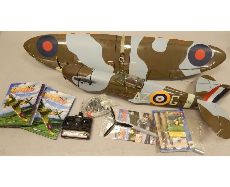 A radio controlled model of a spitfire, complete with motor magazine etc., and a build your own spitfire part kit, with manua