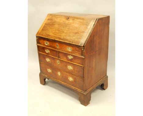 A 18thC walnut bureau, the fall enclosing a fitted interior with doors, drawers, etc, above an arrangement of two short and t