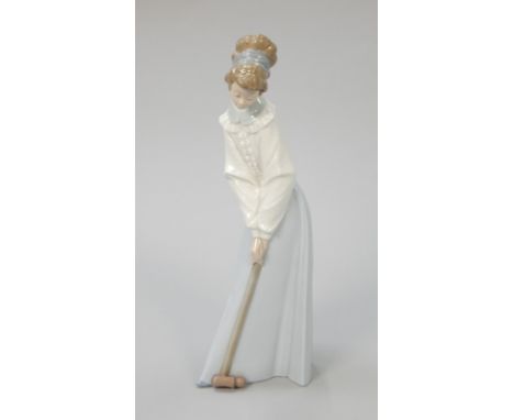 A Nao porcelain figure, modelled in the form of a lady playing croquet, 34cm high