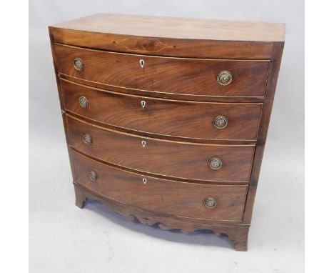 An early 19thC mahogany bow front chest of drawers, with a caddy top above four graduated drawers with circular brass handles