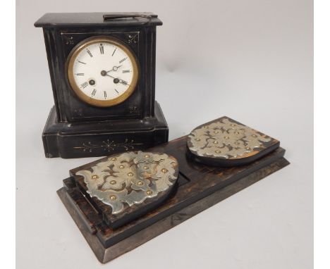 A late 19thC French black slate mantel clock, with white enamel dial and a Victorian calamander book rack, with silver plated