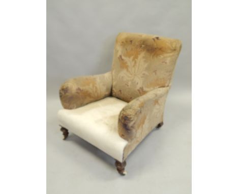 A Victorian walnut armchair, in the manner of Howard & Sons, on turned legs with ceramic castors. Provenance: Thurlby Hall, L