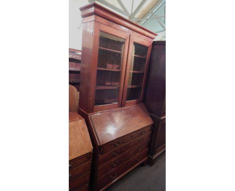 A 19thC mahogany bureau bookcase, the top with a moulded cornice, above two glazed doors, the base with a fall enclosing a fi