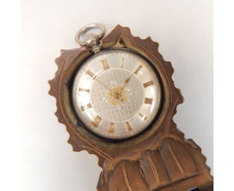 A Black Forest fob watch stand, with a late 19thC Continental fob watch, having engine turned dial, with gilt applied Roman n