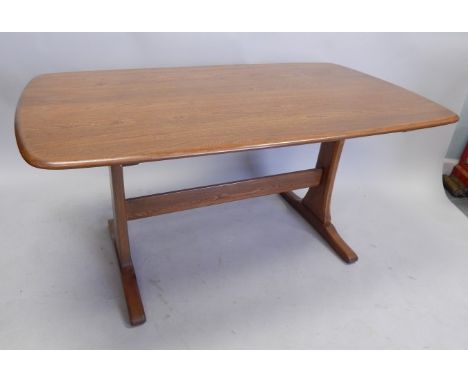 An Ercol type elm kitchen table, the rectangular top with rounded corners and a moulded edge, on end supports, 80cm x 148cm.