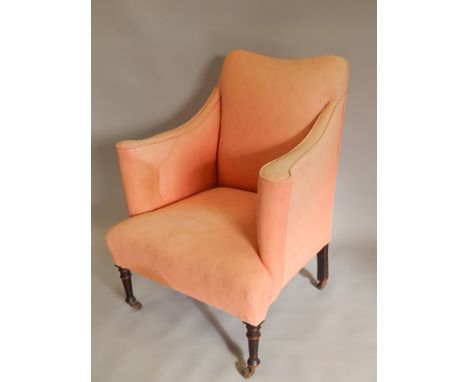 A 19thC mahogany armchair, with a padded back, arms, and seat, upholstered in coral patterned fabric, on turned legs with cer