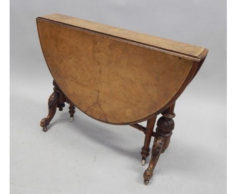 A Victorian burr walnut Sutherland table, the oval quarter veneered top with a moulded edge, on carved and turned end support