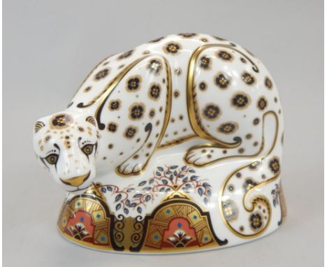 A Royal Crown Derby porcelain snow leopard paperweight, gold button to underside and printed mark in red